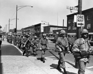 With fixed bayonets, troops of a unit of First Armored Division deploy at 65th and Cottage Grove in Chicago, April 8, 1968. Troops were summoned after rioting developed in some areas of Chicago. (AP Photo)