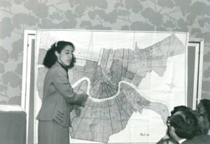 Lani Guinier standing in front of a map